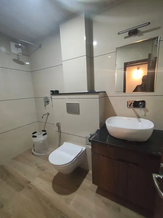 Guest bathroom with a marble vanity and glass shower area