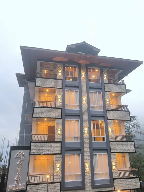 The hotel at twilight with warm light in every balcony