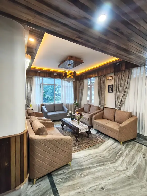 Sitting area with armchairs, a low table and marble flooring